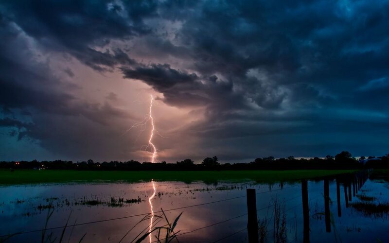 Lightning strike over flooded field