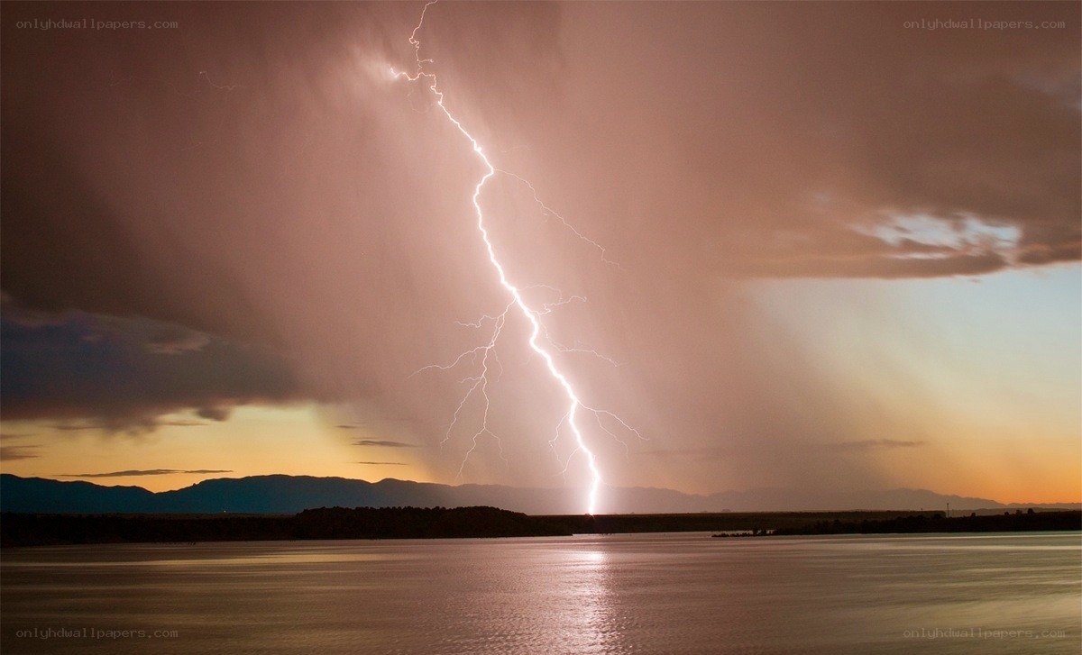 Lightning strike over lake at dusk