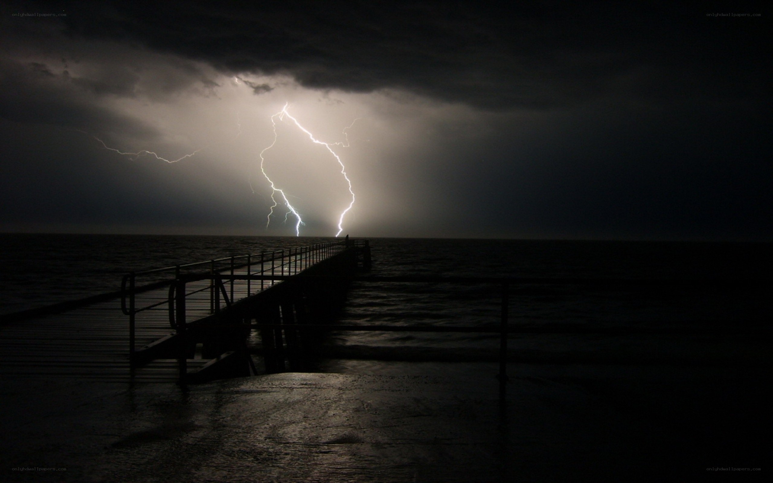 Lightning strike over ocean pier