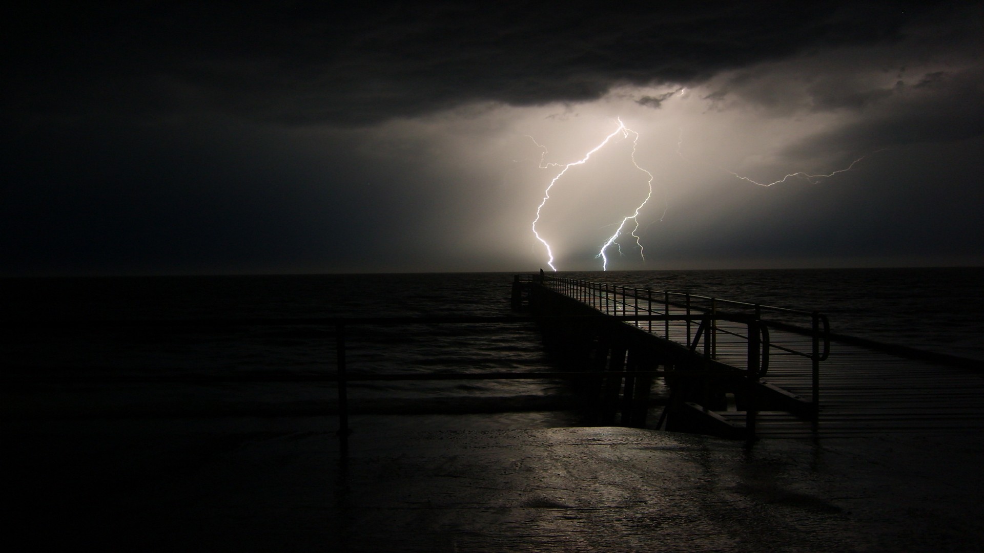 Lightning strike over ocean pier