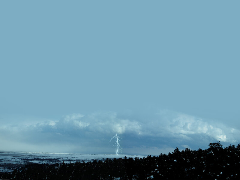 Lightning strike over snowy landscape