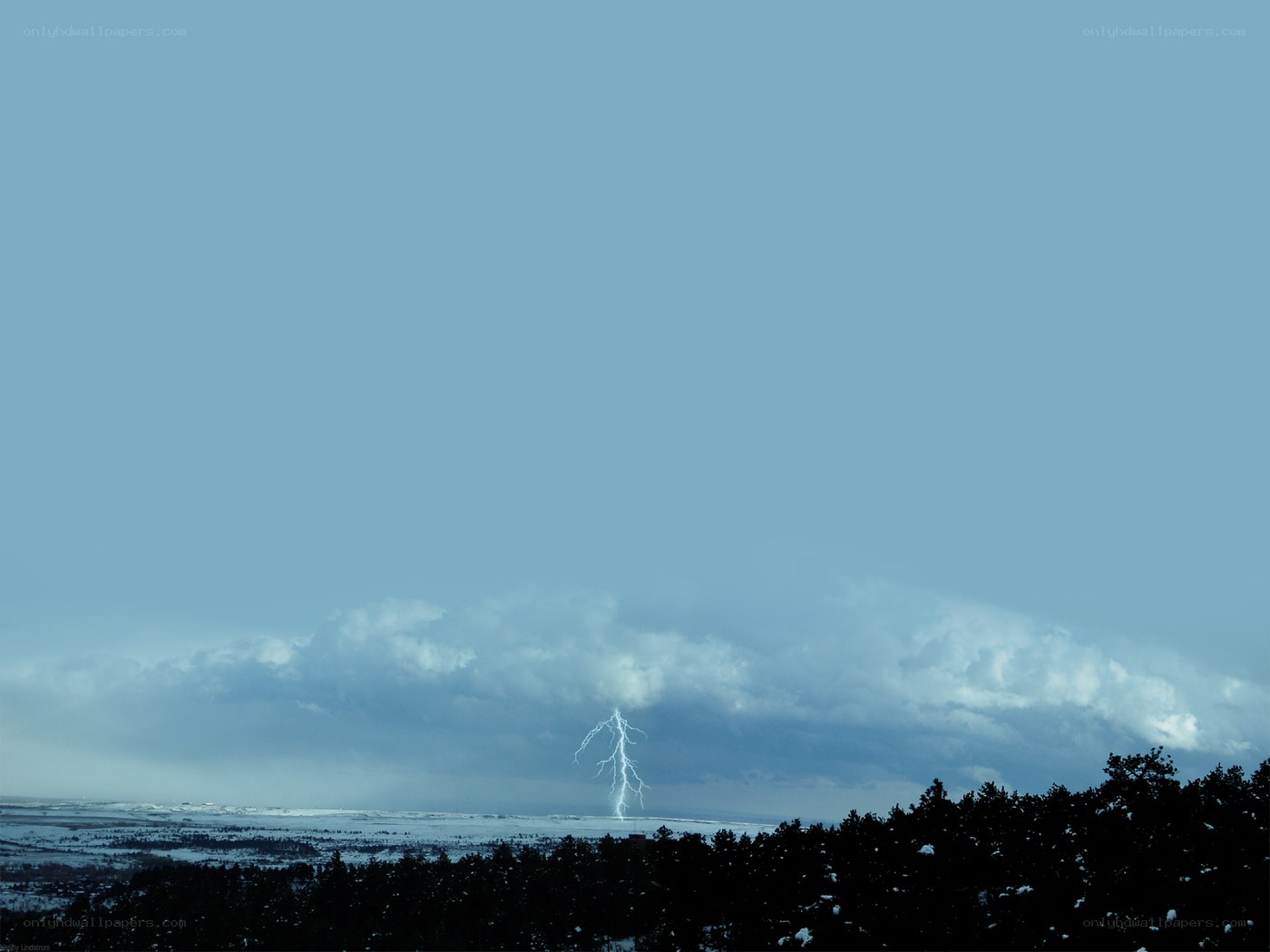 Lightning strike over snowy landscape