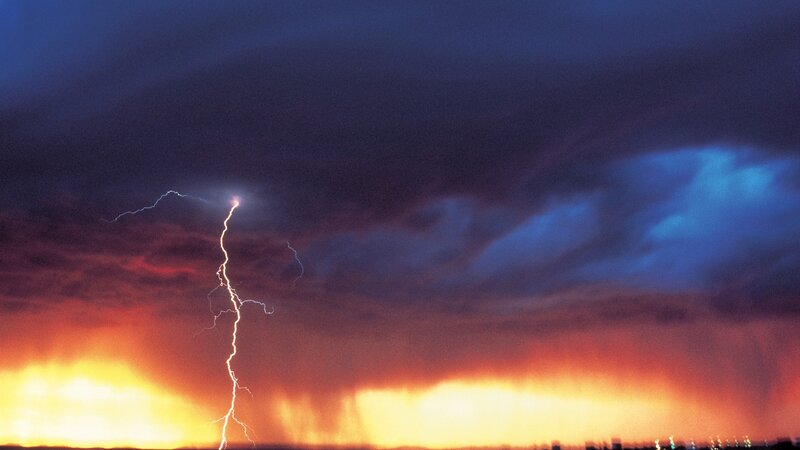 Lightning strike over stormy sky