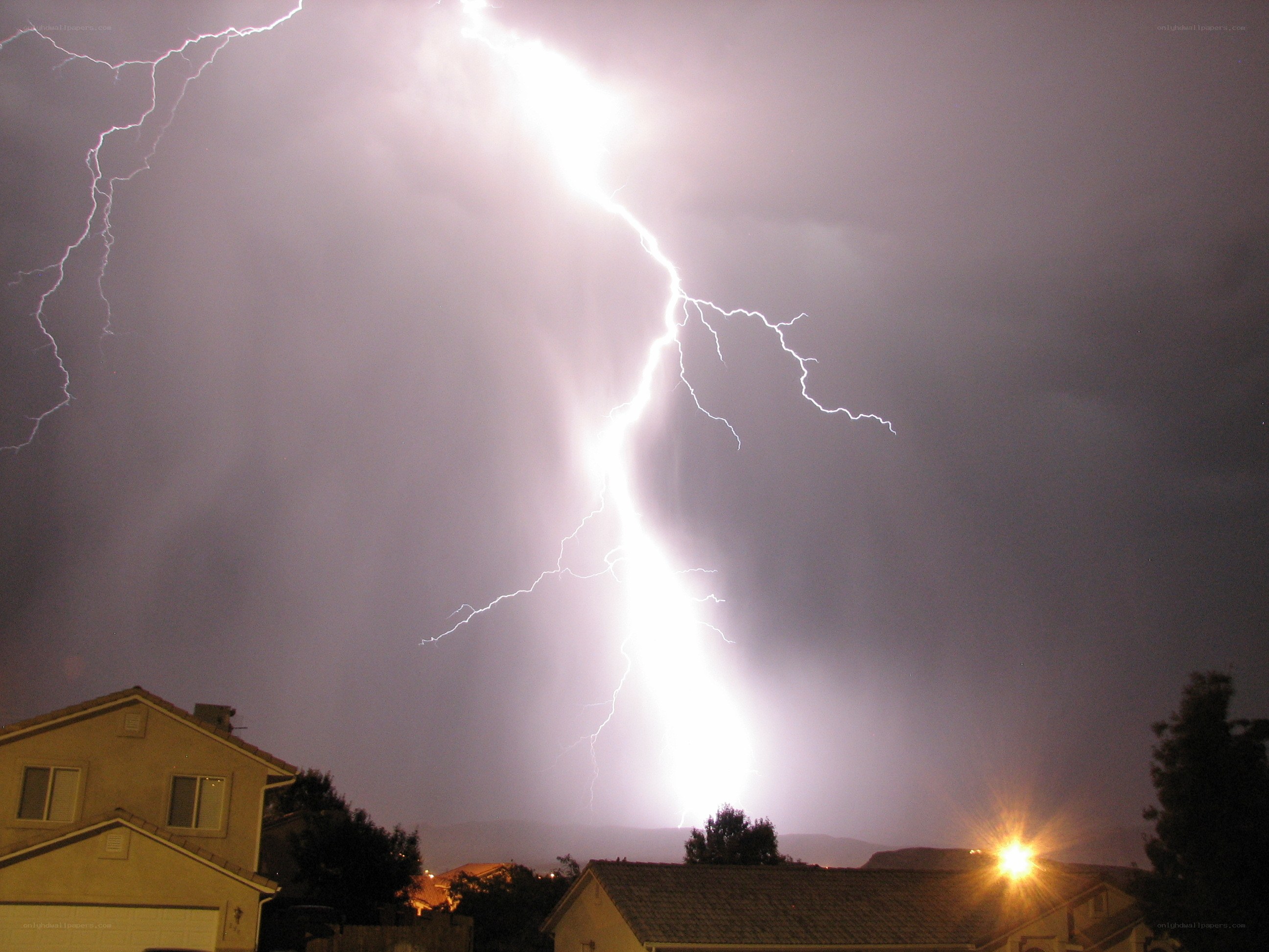 Lightning strike over suburban homes