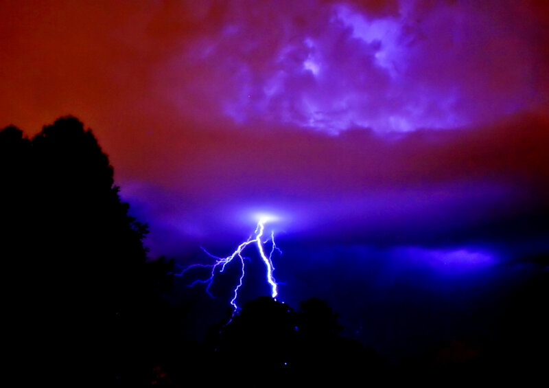 Lightning strike over trees