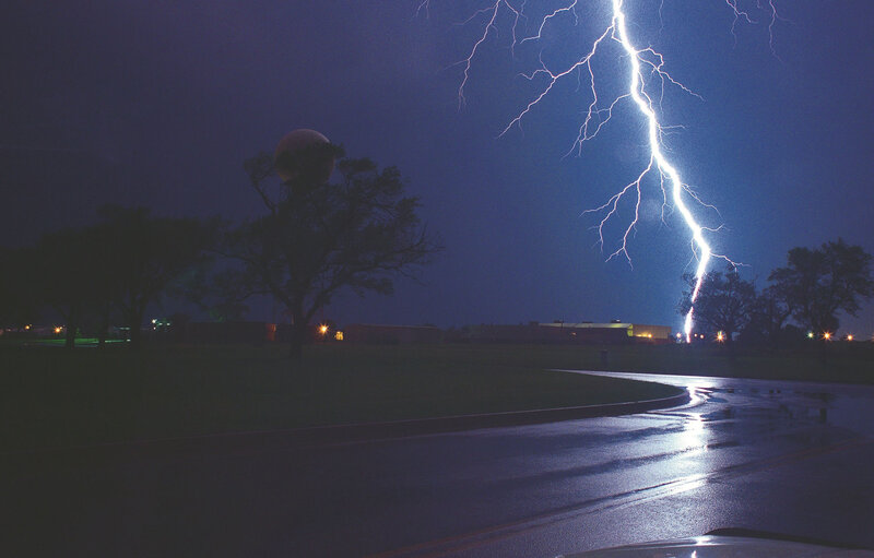 Lightning strike over wet road