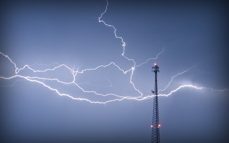 Lightning strikes near a tower