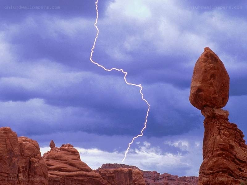 Lightning strikes near rock formations