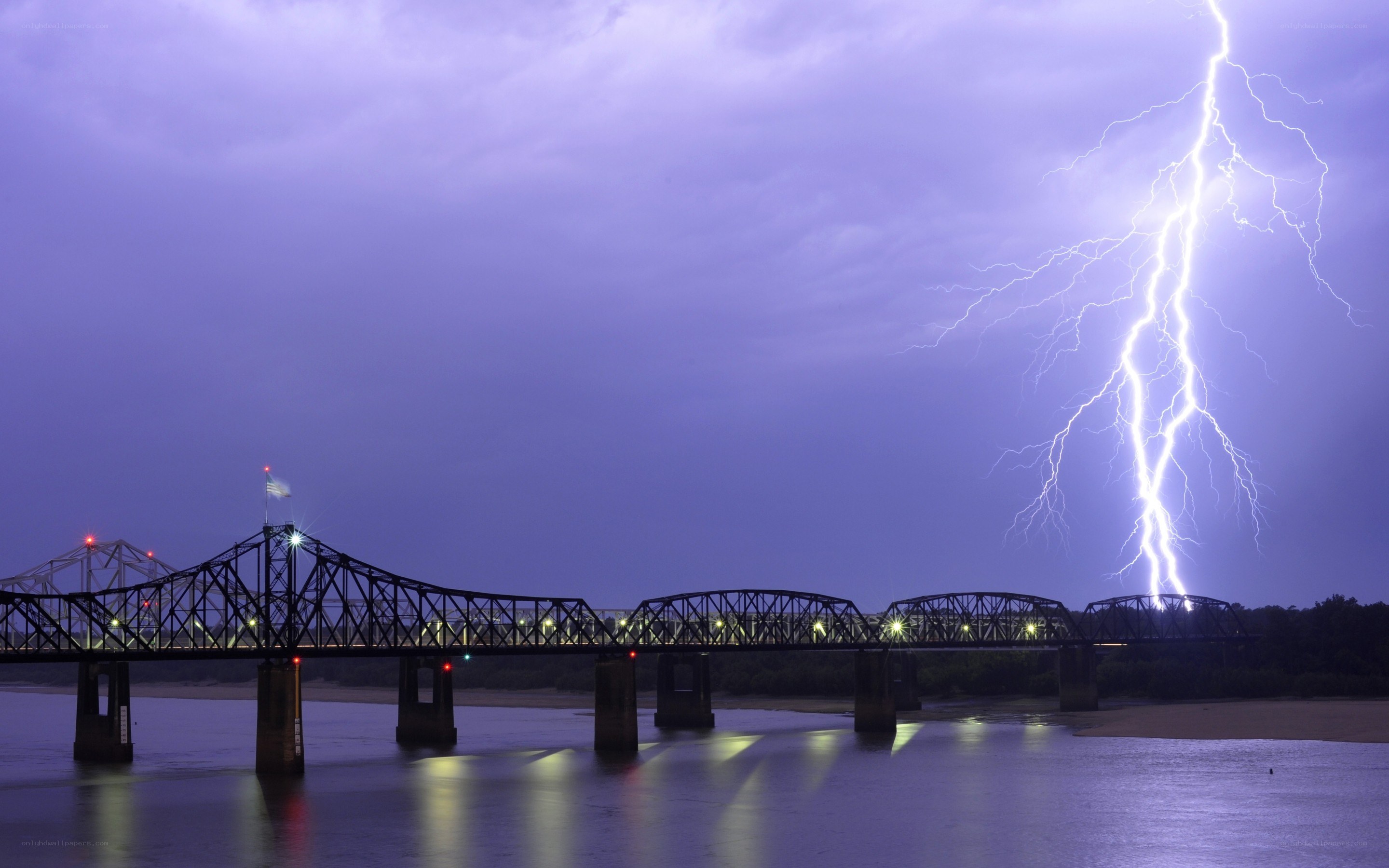 Lightning strikes over a bridge