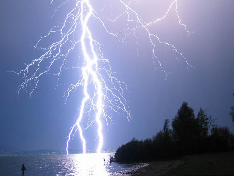Lightning strikes over a lake