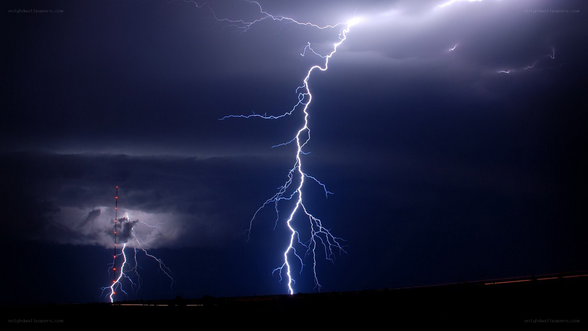Lightning strikes over a tower