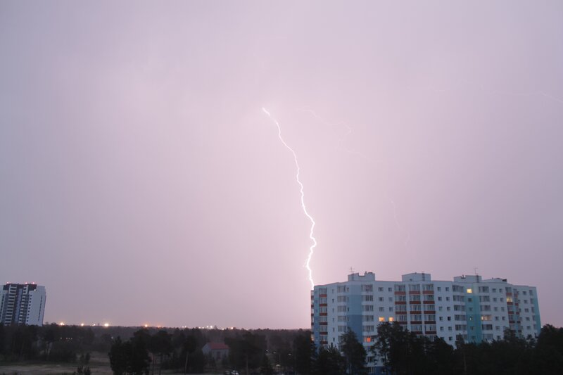 Lightning strikes over apartment buildings