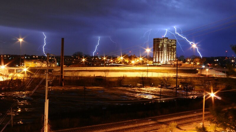 Lightning strikes over city at night