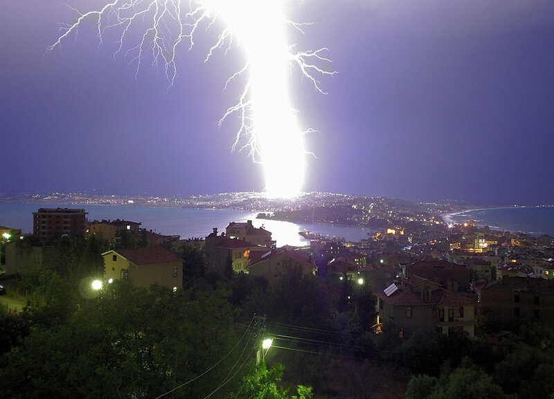Lightning strikes over coastal city