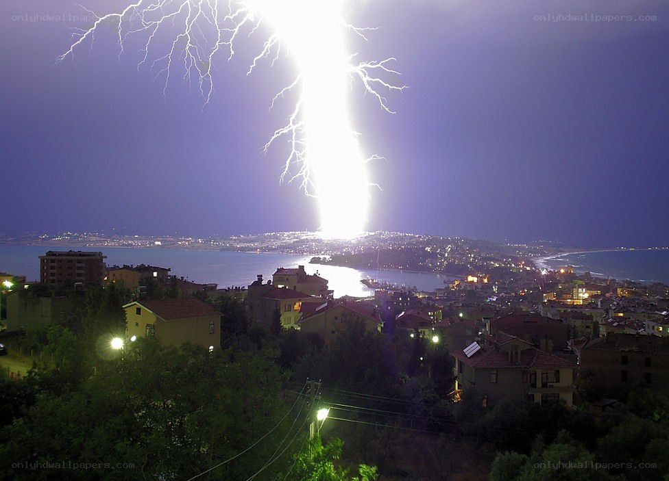Lightning strikes over coastal city