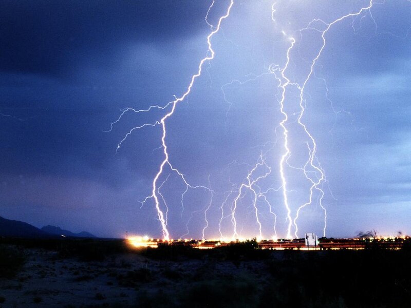 Lightning strikes over desert town