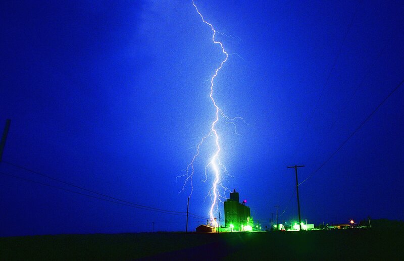 Lightning strikes over grain elevator