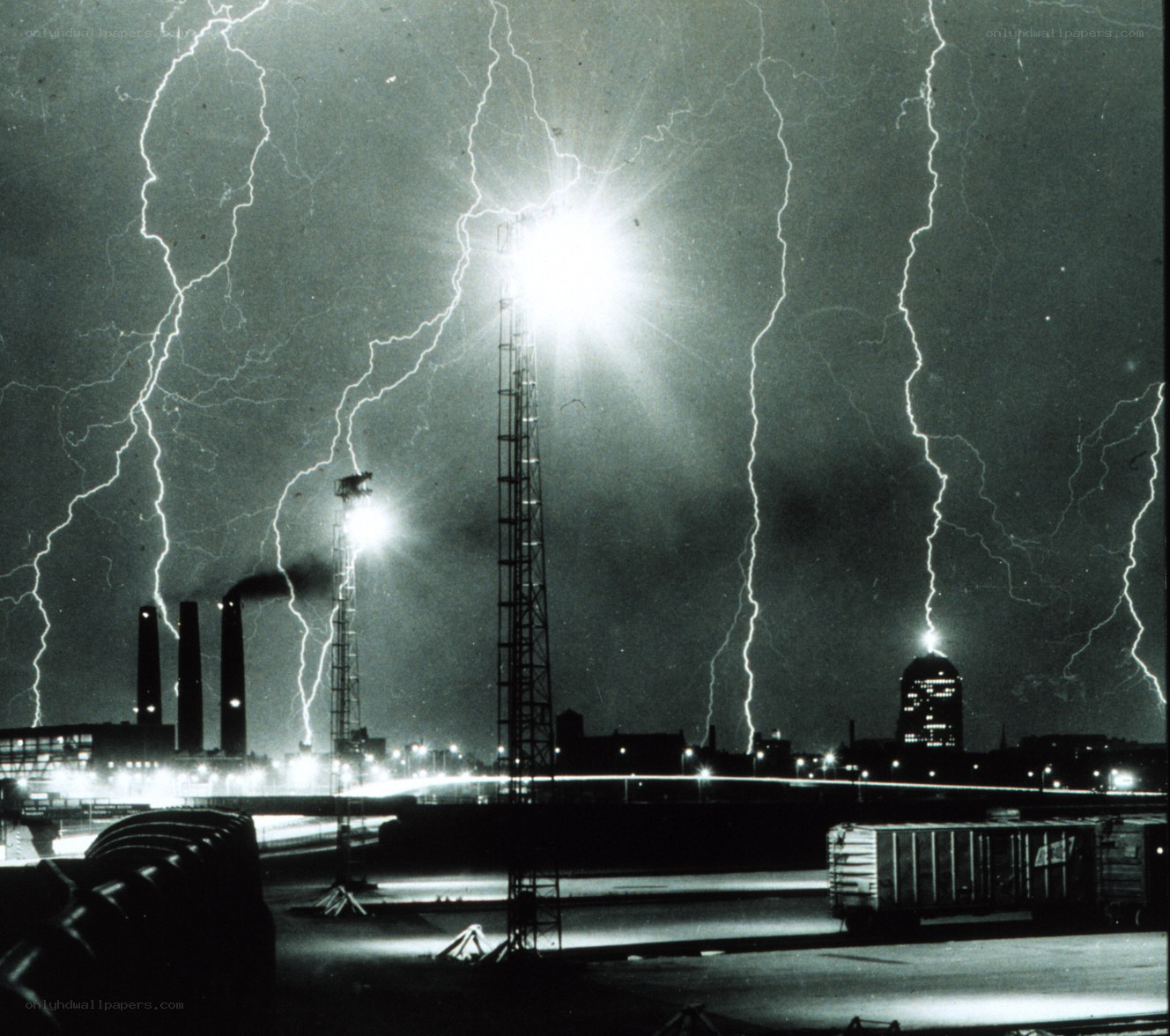 Lightning strikes over industrial city