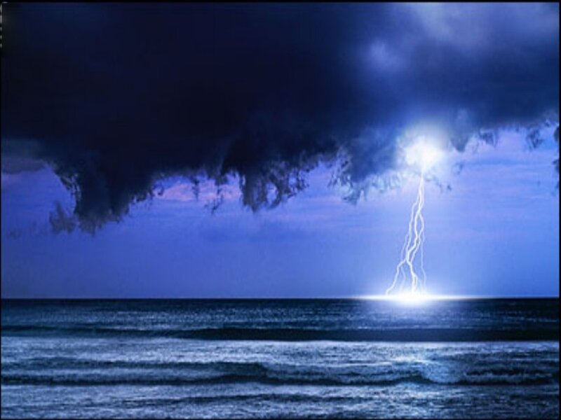 Lightning strikes over the ocean