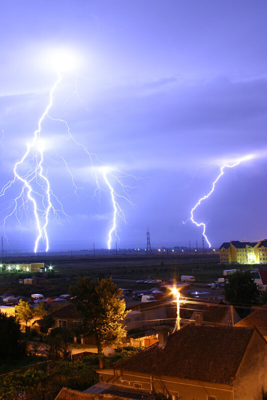 Lightning strikes over town