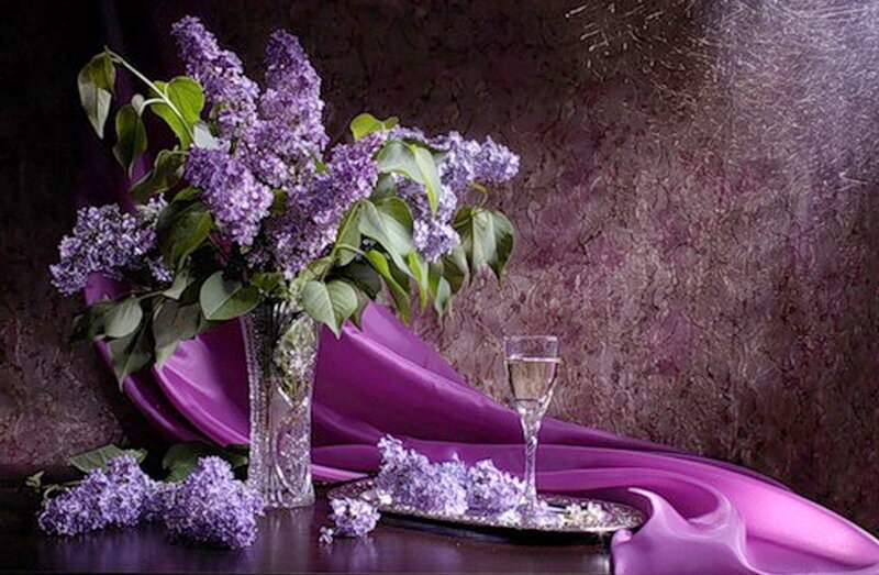 Lilac bouquet with wine glass