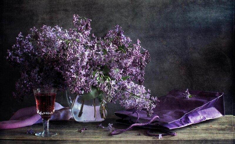 Lilac bouquet with wine glass