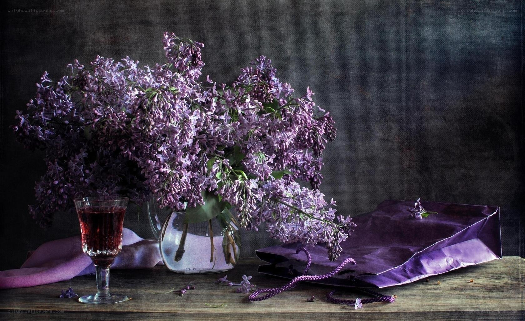 Lilac bouquet with wine glass
