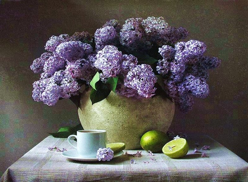 Lilacs and lemons on table