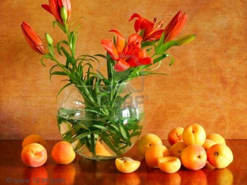 Lilies and apricots in a vase