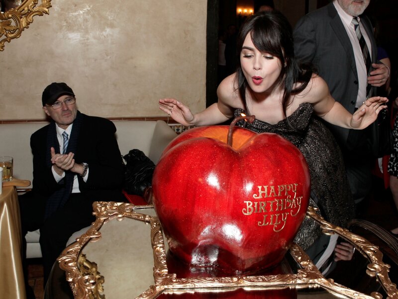 Lily Collins blows out birthday candle