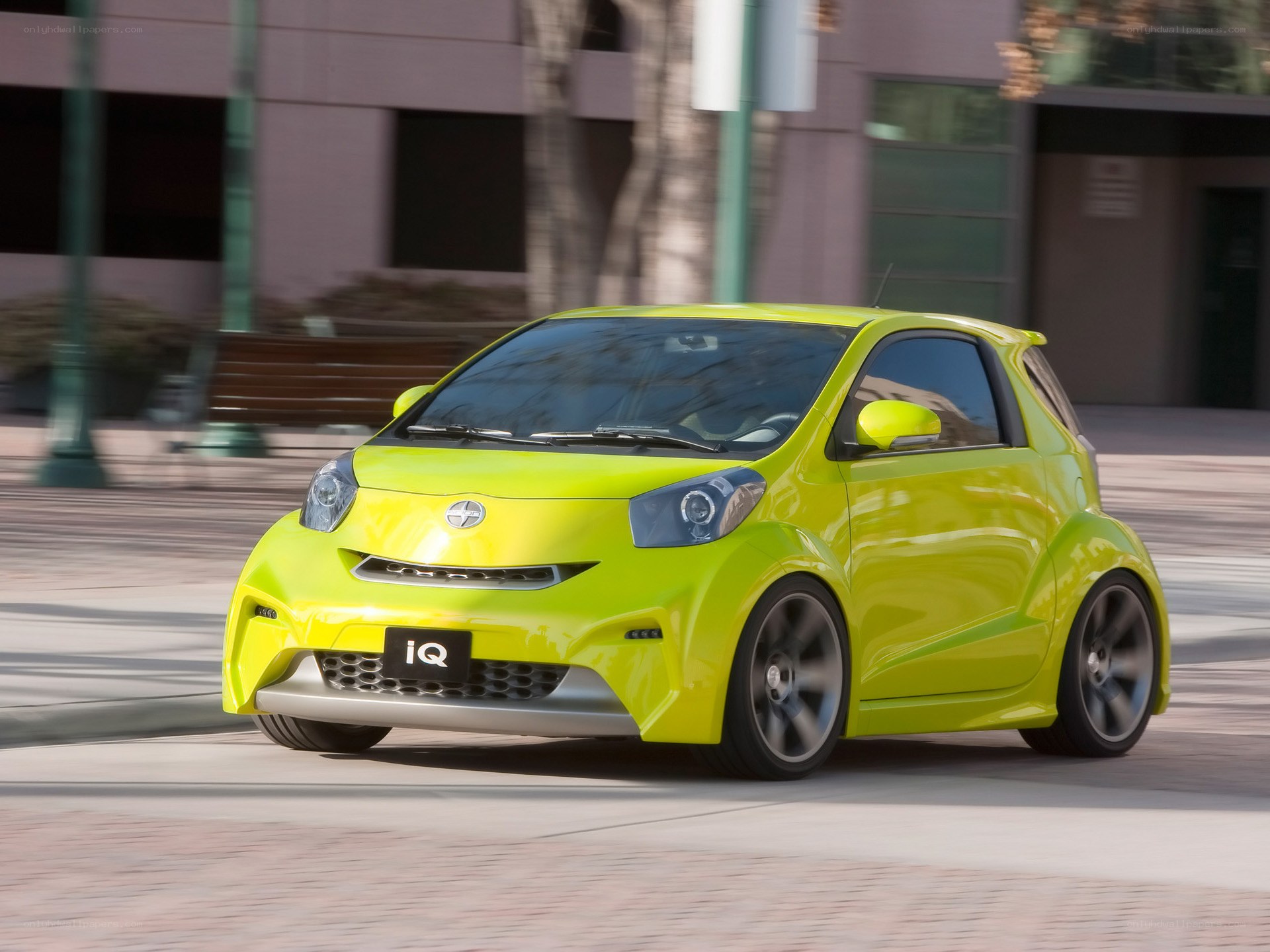 Lime green compact car in motion