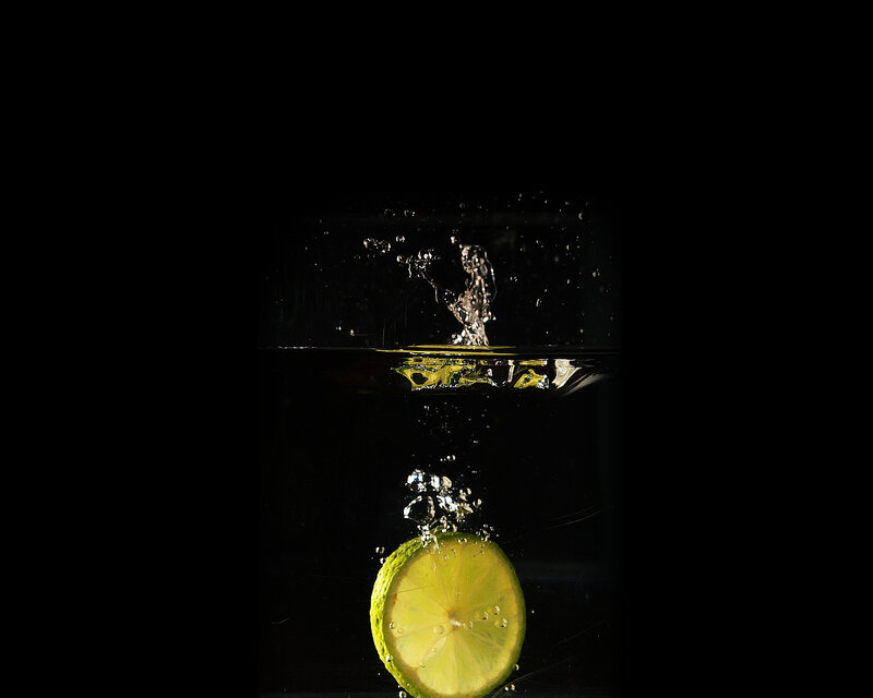 lime slice falling into water
