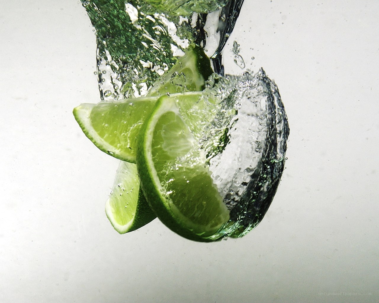 lime slices splashing in water