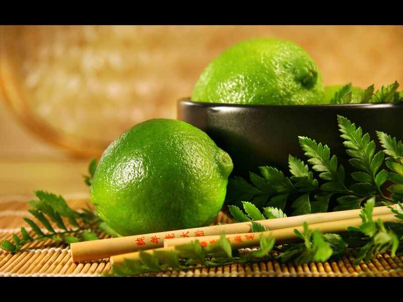 Limes and chopsticks on bamboo