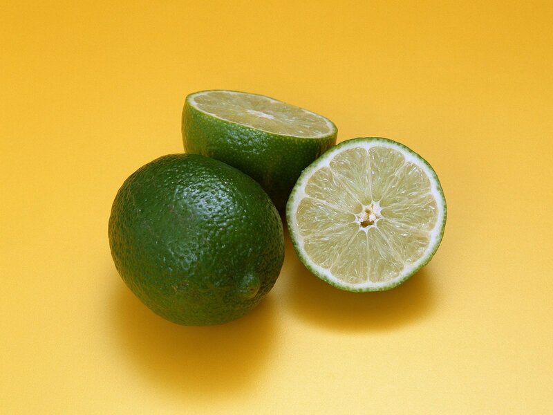 Limes on yellow background