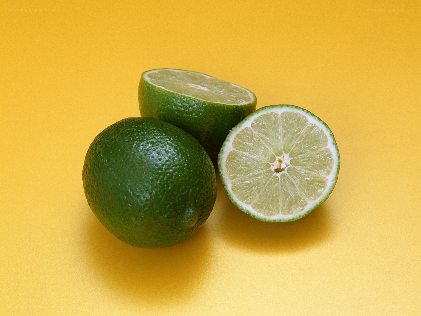 Limes on yellow background