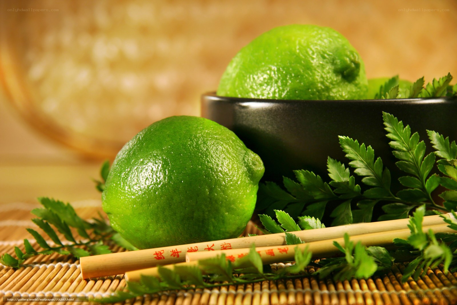 Limes with chopsticks on mat