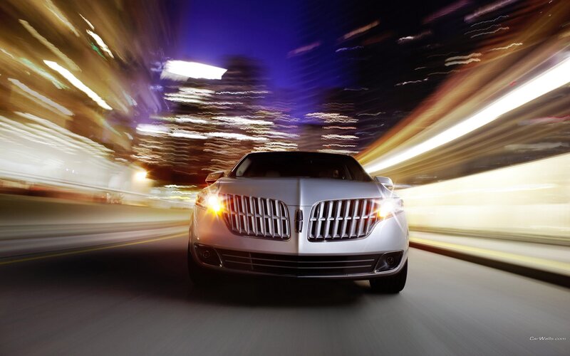 Lincoln car at night with light trails