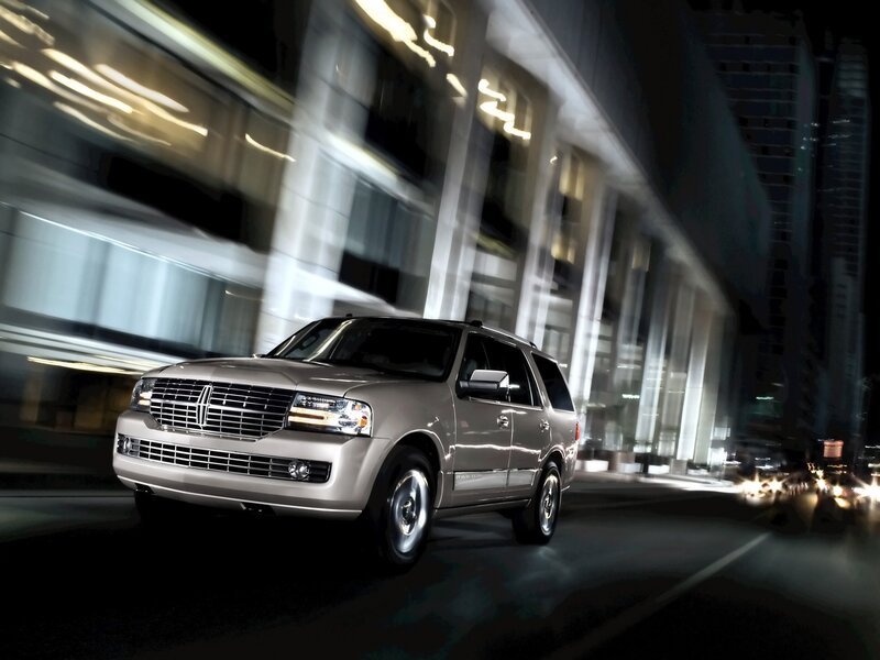 Lincoln SUV in city at night