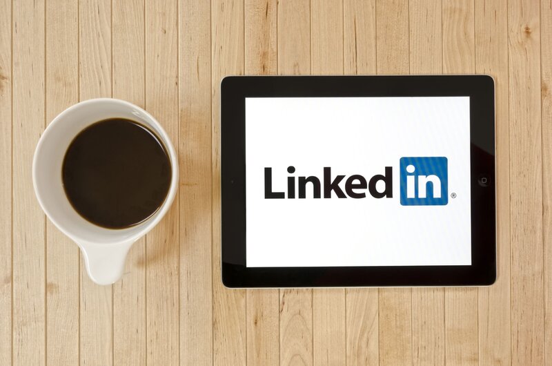 LinkedIn on tablet with coffee