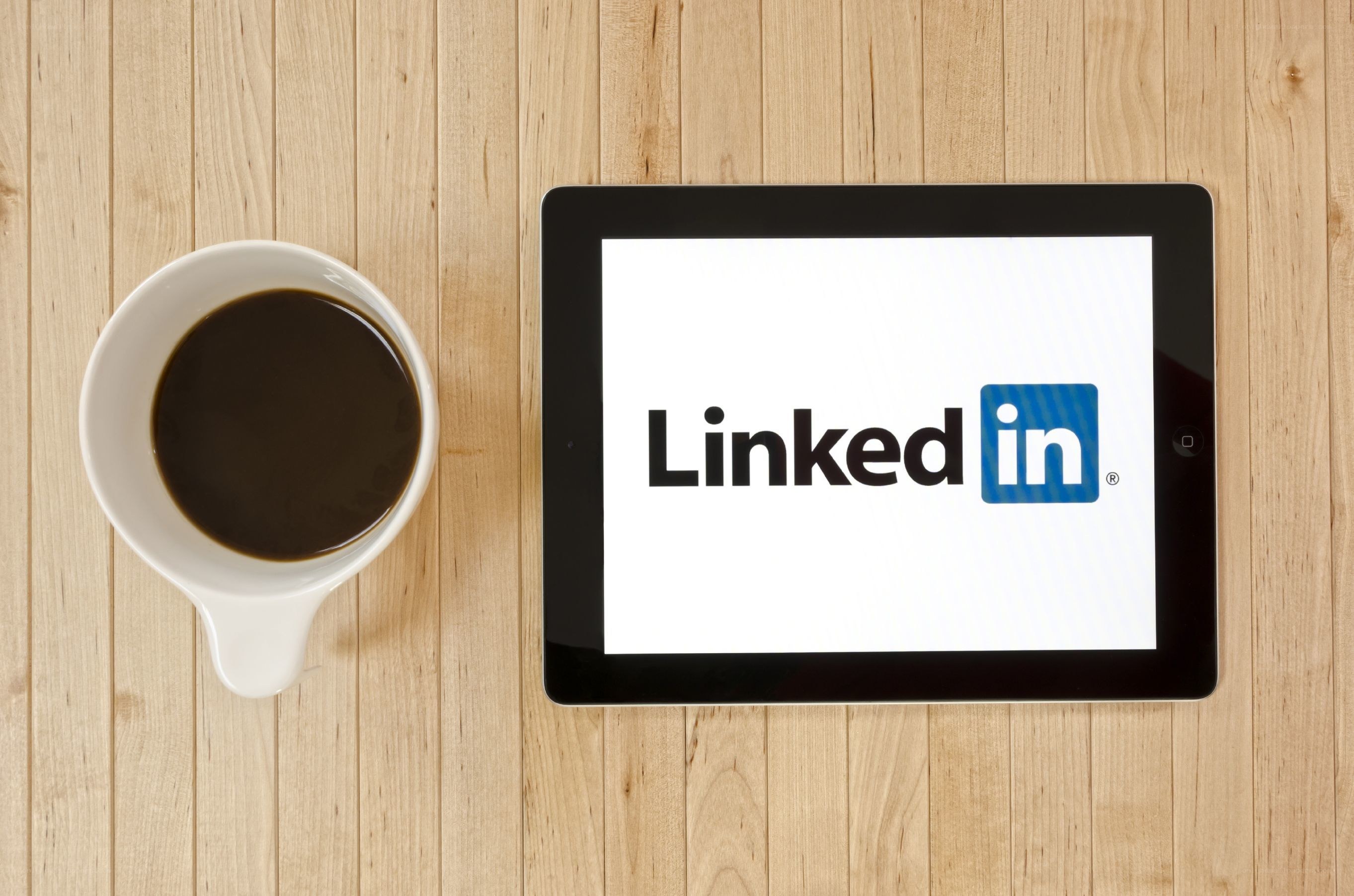LinkedIn on tablet with coffee