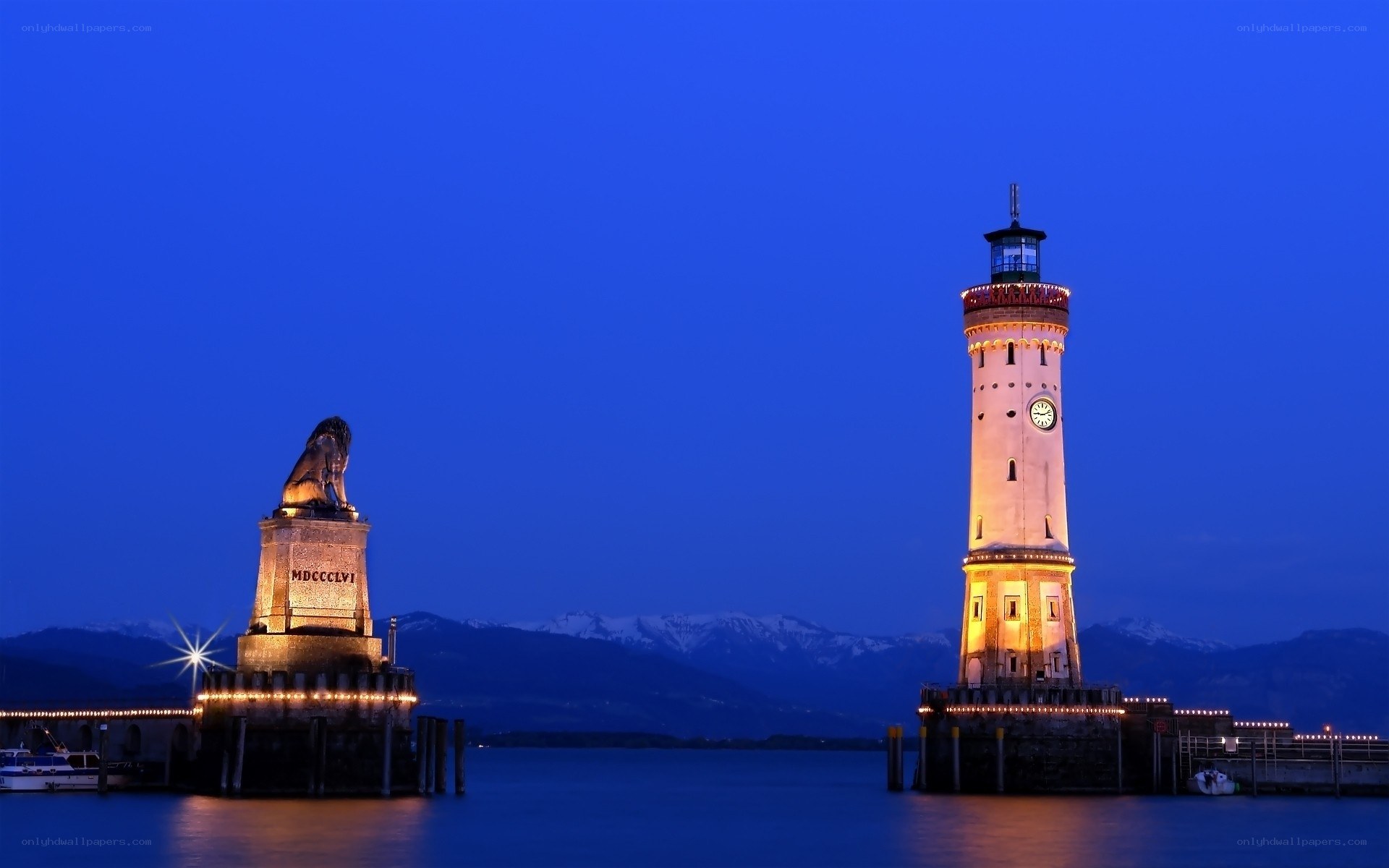 Lion statue and lighthouse at dusk