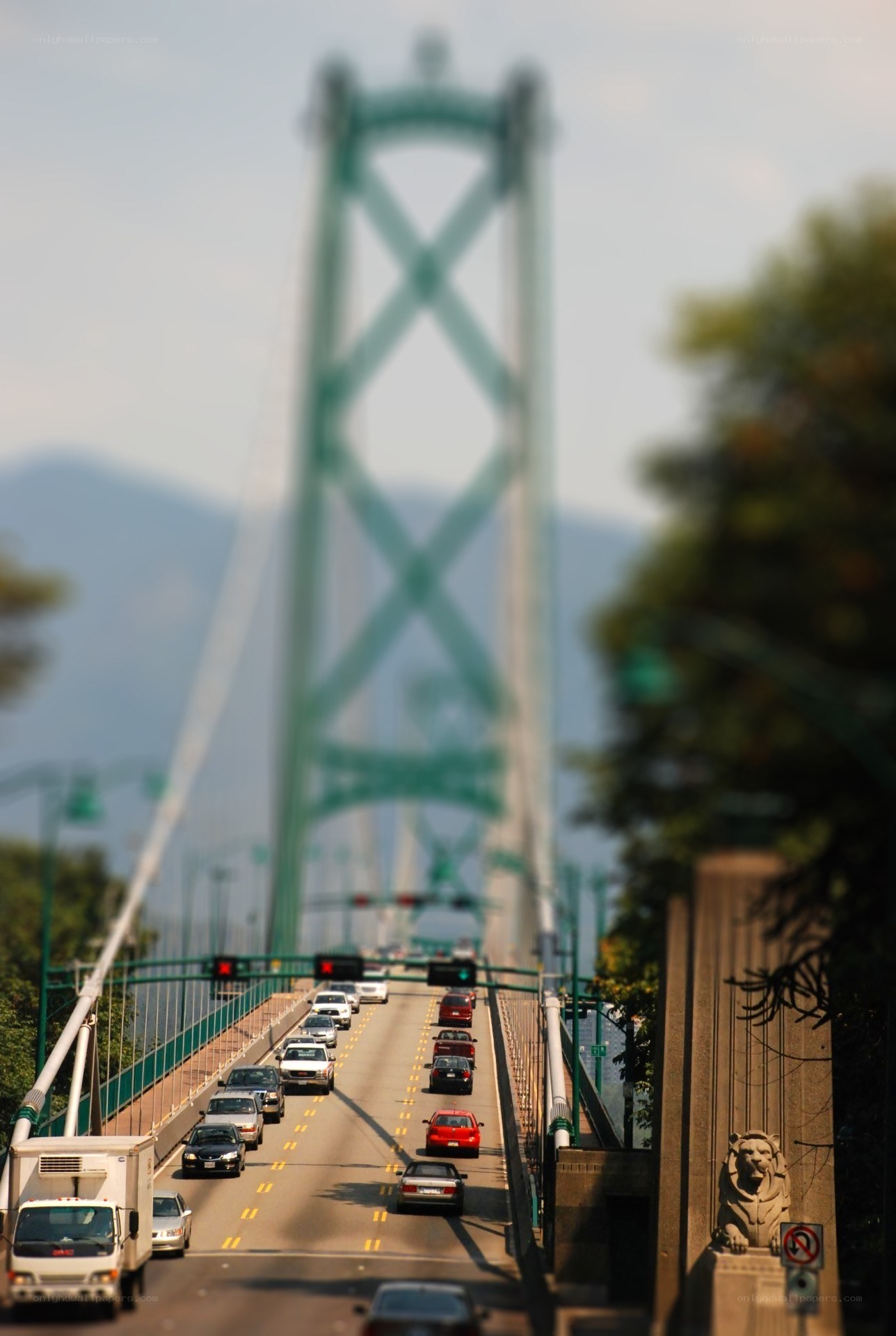Lion statue on bridge with traffic