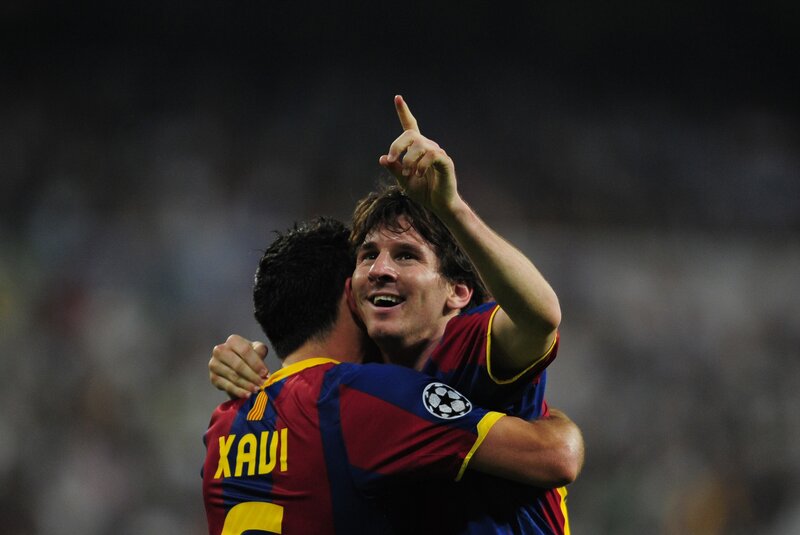 Lionel Messi celebrates with Xavi