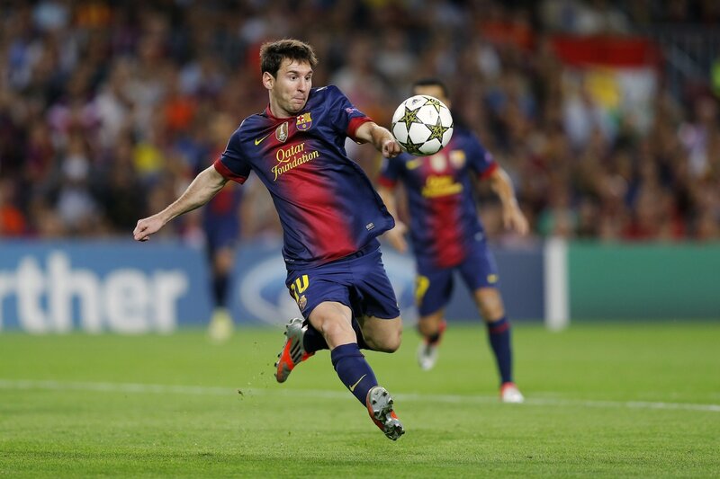 Lionel Messi kicking a soccer ball