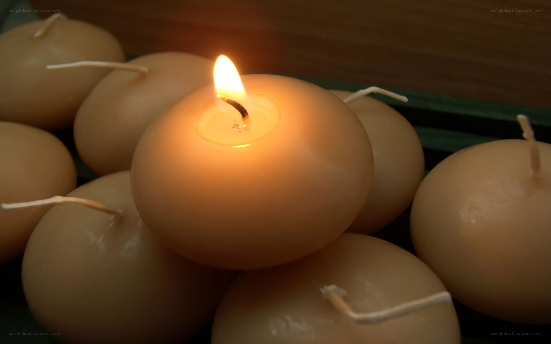 lit candle among others