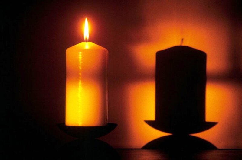 Lit Candle and Shadow