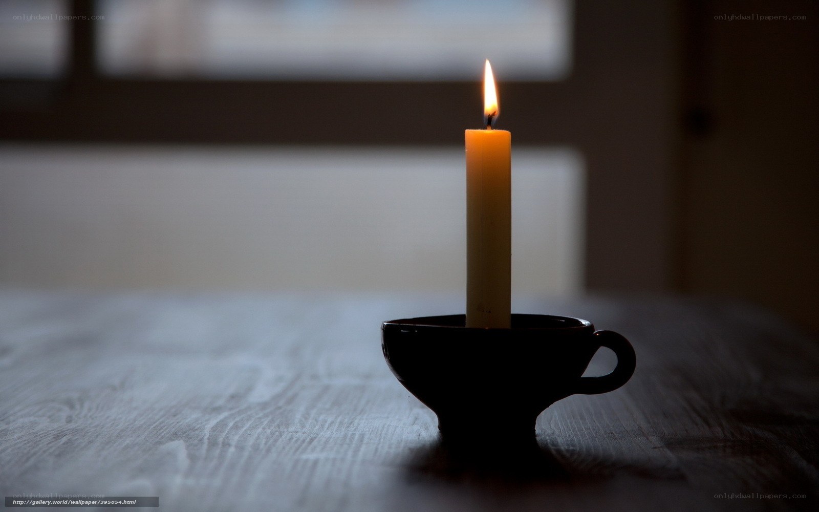 lit candle in a cup