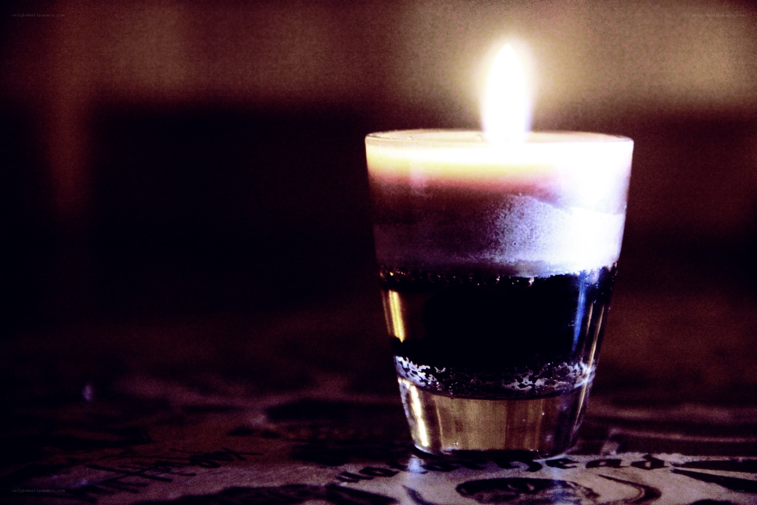 lit candle in a glass