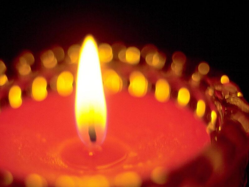 lit candle in dark